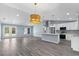 Open concept living space featuring modern lighting, tile flooring, and stainless steel kitchen appliances at 19185 Sherbrooke Ave, Port Charlotte, FL 33954