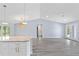 Spacious living room featuring tile flooring, recessed lighting, and a kitchen island with seating at 19185 Sherbrooke Ave, Port Charlotte, FL 33954
