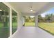 This is the home's screened-in back porch overlooking the lawn and trees at 19185 Sherbrooke Ave, Port Charlotte, FL 33954
