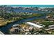 Stunning aerial view of a coastal community with waterfront property, lush greenery, and breathtaking ocean views at 1921 Monte Carlo Dr # 302, Sarasota, FL 34231