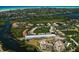 Aerial view of waterfront community with condos, surrounding green spaces, and water access at 1921 Monte Carlo Dr # 302, Sarasota, FL 34231