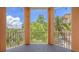 Spacious screened balcony with views of lush greenery and blue skies at 1921 Monte Carlo Dr # 302, Sarasota, FL 34231