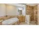 Bright bathroom featuring a soaking tub, walk-in shower, vanity with a vessel sink, and tile accents at 1921 Monte Carlo Dr # 302, Sarasota, FL 34231