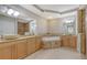 Luxurious bathroom featuring double vanities, a soaking tub, and elegant tile work at 1921 Monte Carlo Dr # 302, Sarasota, FL 34231