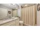 Bathroom featuring a granite vanity top, neutral color scheme, and framed mirror, exuding a sense of refined comfort at 1921 Monte Carlo Dr # 302, Sarasota, FL 34231