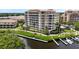 Luxury waterfront condo building with private boat docks and lush landscaping at 1921 Monte Carlo Dr # 302, Sarasota, FL 34231