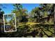 Fenced dog park area with a grassy field and mature trees, perfect for pet owners at 1921 Monte Carlo Dr # 302, Sarasota, FL 34231
