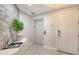 Modern entryway featuring an elevator, textured accent wall, and stylish decor at 1921 Monte Carlo Dr # 302, Sarasota, FL 34231