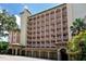 Beautiful multi-story condo building featuring private balconies and covered parking, set in a lush, tropical landscape at 1921 Monte Carlo Dr # 302, Sarasota, FL 34231