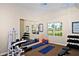 Bright fitness center with exercise equipment, mirrored wall, and natural light, encouraging a healthy and active lifestyle at 1921 Monte Carlo Dr # 302, Sarasota, FL 34231