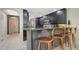 Contemporary kitchen with bar seating, granite countertops, and modern appliances at 1921 Monte Carlo Dr # 302, Sarasota, FL 34231