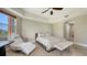 Spacious main bedroom featuring a tray ceiling, neutral tones, wood flooring, and an ensuite bathroom at 1921 Monte Carlo Dr # 302, Sarasota, FL 34231