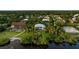 Waterfront home surrounded by mature tropical landscaping and lush greenery, with backyard access to the water at 2048 Larson St, Englewood, FL 34223