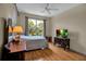 Cozy bedroom with a large window overlooking the lush greenery at 2048 Larson St, Englewood, FL 34223