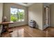 Versatile room with hardwood floors and a large window offering natural light and a view of the outdoors at 2048 Larson St, Englewood, FL 34223