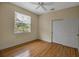 Bedroom with wood floors, closet, and a window at 2048 Larson St, Englewood, FL 34223