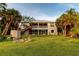 Exterior view of the home with a large backyard and patio at 2048 Larson St, Englewood, FL 34223