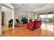 Bright living room with hardwood floors, comfortable seating, and access to a scenic balcony with water views at 2048 Larson St, Englewood, FL 34223