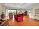 Spacious living room featuring wood floors, tray ceilings, and sliding doors opening to a scenic balcony at 2048 Larson St, Englewood, FL 34223