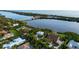 Aerial view of waterfront homes in a scenic community, showcasing proximity to the bay and lush landscaping at 2048 Larson St, Englewood, FL 34223