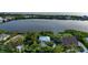 Aerial view of a waterfront home surrounded by lush greenery, offering serene water views and a private setting at 2048 Larson St, Englewood, FL 34223