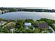 Aerial view of a waterfront home surrounded by lush greenery, offering serene water views and a private setting at 2048 Larson St, Englewood, FL 34223