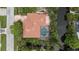 Aerial view of a stunning home with a tile roof, screened pool, and lush landscaping at 205 Sugarloaf Dr, Nokomis, FL 34275
