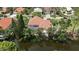 Beautiful waterfront home with screened pool, mature landscaping, and tile roof at 205 Sugarloaf Dr, Nokomis, FL 34275