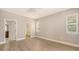 Spacious bedroom with light wood floors, a ceiling fan, and large windows, providing a bright and airy atmosphere at 205 Sugarloaf Dr, Nokomis, FL 34275