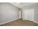 Neutral bedroom featuring wood-look floors, walk-in closet, and a crisp, clean design at 205 Sugarloaf Dr, Nokomis, FL 34275