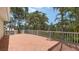 Spacious outdoor deck with white railing, offering serene views of the lush green landscape at 205 Sugarloaf Dr, Nokomis, FL 34275