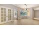 Bright dining area with tile flooring and a view of the pool through large bay windows, creating a welcoming space at 205 Sugarloaf Dr, Nokomis, FL 34275
