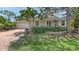 Charming single-Gathering home with a well-manicured lawn and a red brick driveway at 205 Sugarloaf Dr, Nokomis, FL 34275