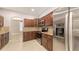 Modern kitchen with stainless steel appliances, granite countertops, and wood cabinets at 205 Sugarloaf Dr, Nokomis, FL 34275