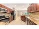 Well-equipped kitchen with granite countertops, stainless steel appliances, and custom cabinets at 205 Sugarloaf Dr, Nokomis, FL 34275