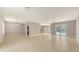 Spacious living room with tile flooring and French doors to the backyard at 205 Sugarloaf Dr, Nokomis, FL 34275