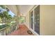 Covered patio with brick flooring, offers a charming view of the surrounding greenery at 205 Sugarloaf Dr, Nokomis, FL 34275