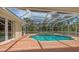 Inviting screened-in pool and spa area with brick patio, ideal for relaxation and entertainment at 205 Sugarloaf Dr, Nokomis, FL 34275