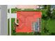 Birds eye view of red-roofed home featuring a screened pool and well-manicured backyard at 2148 Date Palm Way, Venice, FL 34292