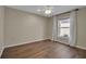 Comfortable bedroom with a window with sheer curtains and durable wood-look floors at 2148 Date Palm Way, Venice, FL 34292