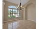 Bright dining room with modern chandelier and a large window at 2148 Date Palm Way, Venice, FL 34292