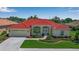 Beautiful home featuring a red tile roof, well-manicured lawn, and a two car garage at 2148 Date Palm Way, Venice, FL 34292