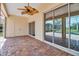 Screened lanai with brick flooring, ceiling fan and sliding glass doors to the pool and backyard at 2148 Date Palm Way, Venice, FL 34292