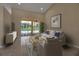 Cozy living room with a comfortable couch, stylish decor, and sliding glass doors to the backyard at 2148 Date Palm Way, Venice, FL 34292