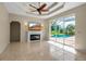 Large living room with a fireplace and view of the screened-in pool at 2148 Date Palm Way, Venice, FL 34292