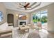 Comfortable living room with a fireplace and view of the screened-in pool at 2148 Date Palm Way, Venice, FL 34292