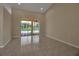 Spacious living room area with tile flooring, high ceilings and sliding glass doors at 2148 Date Palm Way, Venice, FL 34292