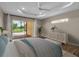 Bright main bedroom featuring a tray ceiling, wood floors, and sliding glass doors at 2148 Date Palm Way, Venice, FL 34292