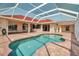 Relaxing backyard pool area with a screened-in patio and brick pavers at 2148 Date Palm Way, Venice, FL 34292