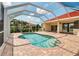 Screened pool with red brick patio and steps, attached to a well maintained home at 2148 Date Palm Way, Venice, FL 34292